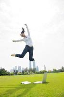 woman with laptop in park photo