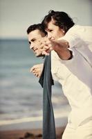 happy young couple have fun at beautiful beach photo