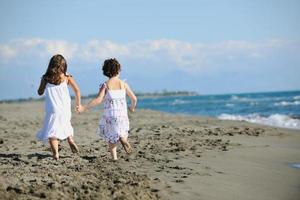 cute little girls running on beach photo