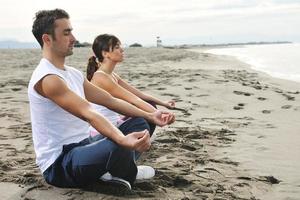 couple yoga beach photo