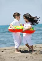 happy young  people group have fun on beach photo