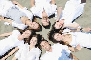 Group of happy young people in have fun at beach photo