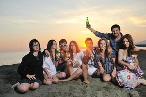 Group of young people enjoy summer  party at the beach photo