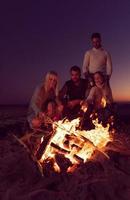 Friends having fun at beach on autumn day photo