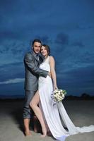 romantic beach wedding at sunset photo