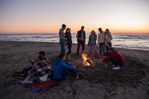 Friends having fun at beach on autumn day photo