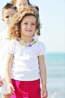 happy child group playing  on beach photo