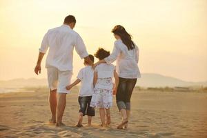 happy young family have fun on beach at sunset photo