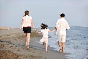 happy young family have fun on beach photo