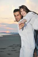 happy young couple have fun on beach photo