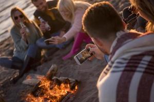 Friends having fun at beach on autumn day photo