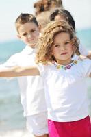 happy child group playing  on beach photo