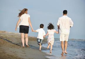 happy young family have fun on beach photo