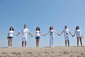 happy people group have fun and running on beach photo