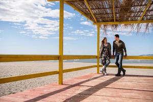 Couple chating and having fun at beach bar photo