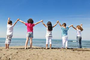 happy young  people group have fun on beach photo