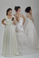 portrait of a three beautiful woman in wedding dress photo