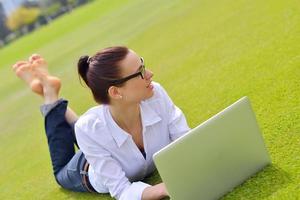 woman with laptop in park photo