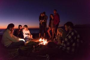 Friends having fun at beach on autumn day photo