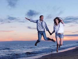 young couple  on beach have fun photo