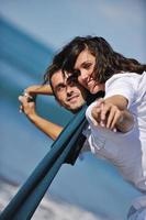 happy young couple have fun at beautiful beach photo