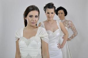 portrait of a three beautiful woman in wedding dress photo