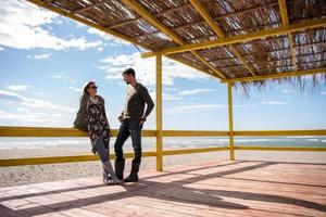 Couple chating and having fun at beach bar photo