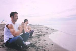 couple yoga beach photo