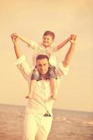 happy father and son have fun and enjoy time on beach photo