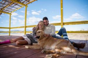 Couple with dog enjoying time on beach photo