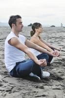 couple yoga beach photo