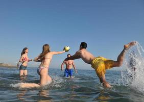 young people group have fun and play beach volleyball photo