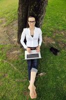 woman with laptop in park photo