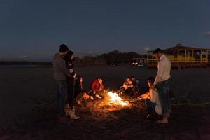 Friends having fun at beach on autumn day photo