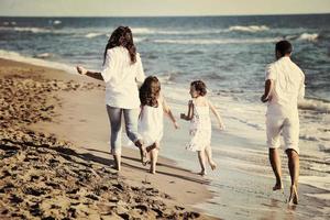 happy young  family have fun on beach photo