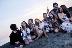 Group of young people enjoy summer  party at the beach photo