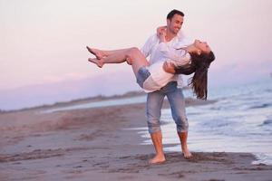 young couple  on beach have fun photo