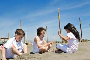 happy child group playing  on beach photo