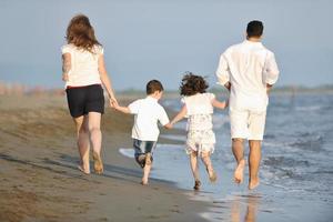 happy young family have fun on beach photo