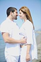 happy young couple have fun on beach photo