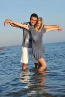 happy young couple have romantic time on beach photo