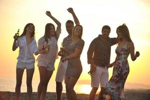 Group of young people enjoy summer  party at the beach photo