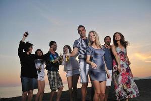 Group of young people enjoy summer  party at the beach photo