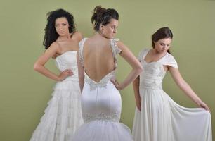 portrait of a three beautiful woman in wedding dress photo