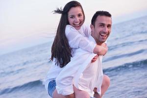 young couple  on beach have fun photo