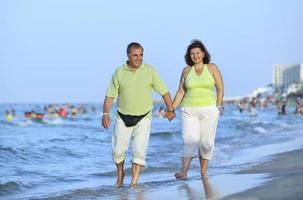 happy seniors couple  on beach photo