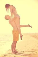 happy young couple have romantic time on beach photo