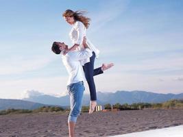 young couple  on beach have fun photo