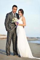 romantic beach wedding at sunset photo