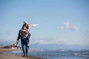 couple having fun at beach during autumn photo